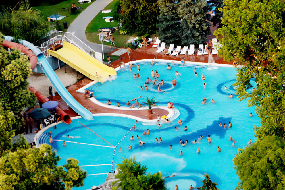 An aerial view of the crowded outdoor recreational pool at Romai furdo