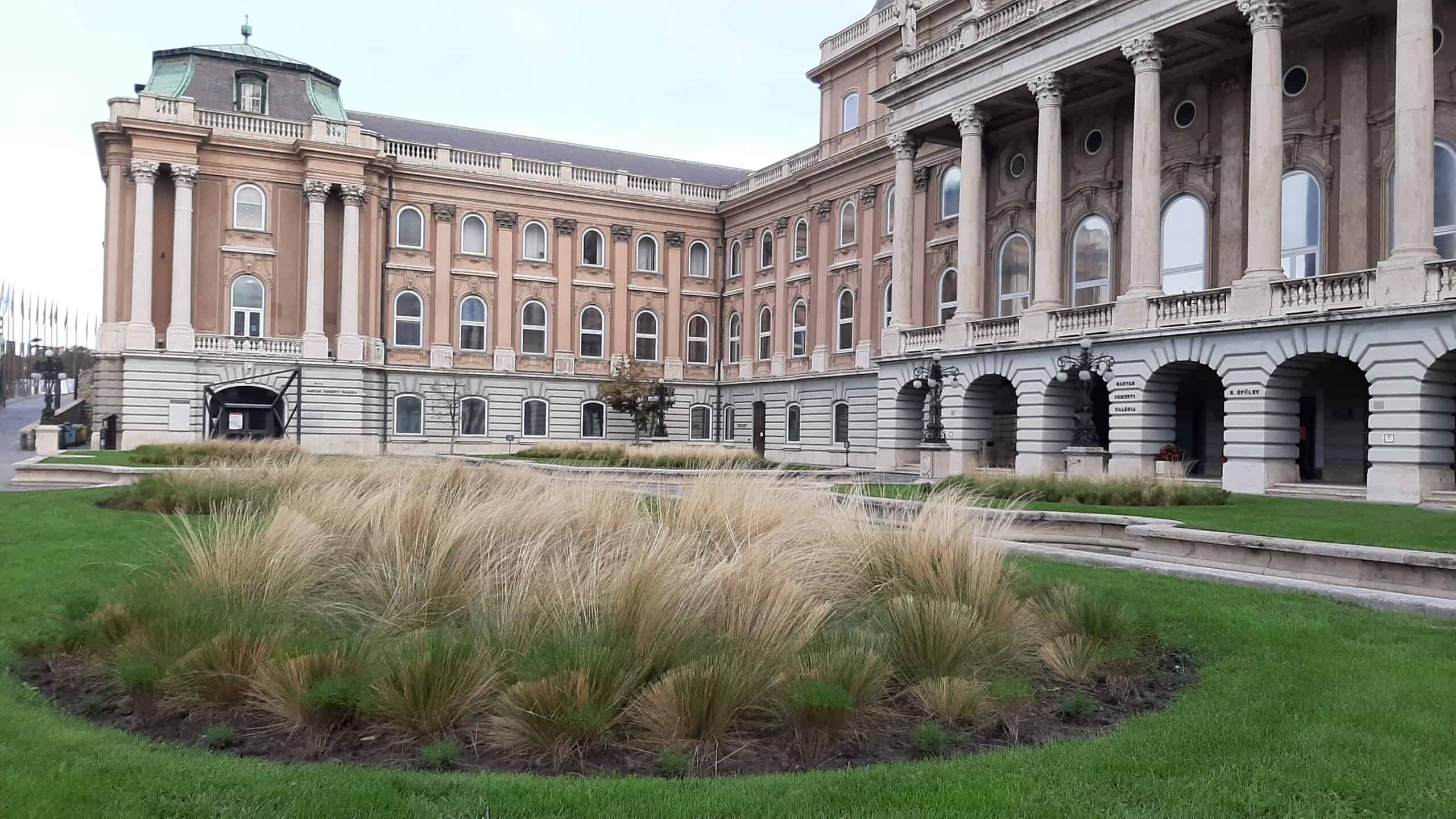 Looking across the wide cobbled courtyard toward the sprawling Royal Palace