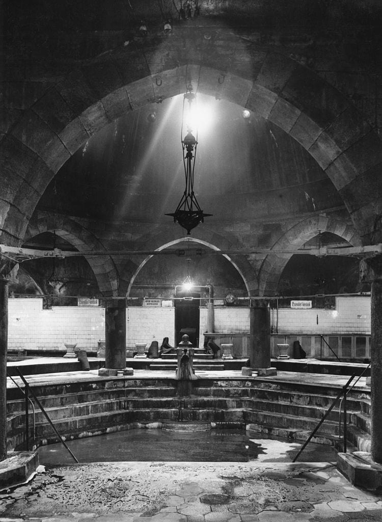 People enjoying the rooftop panorama thermal pool at Rudas Baths in Budapest