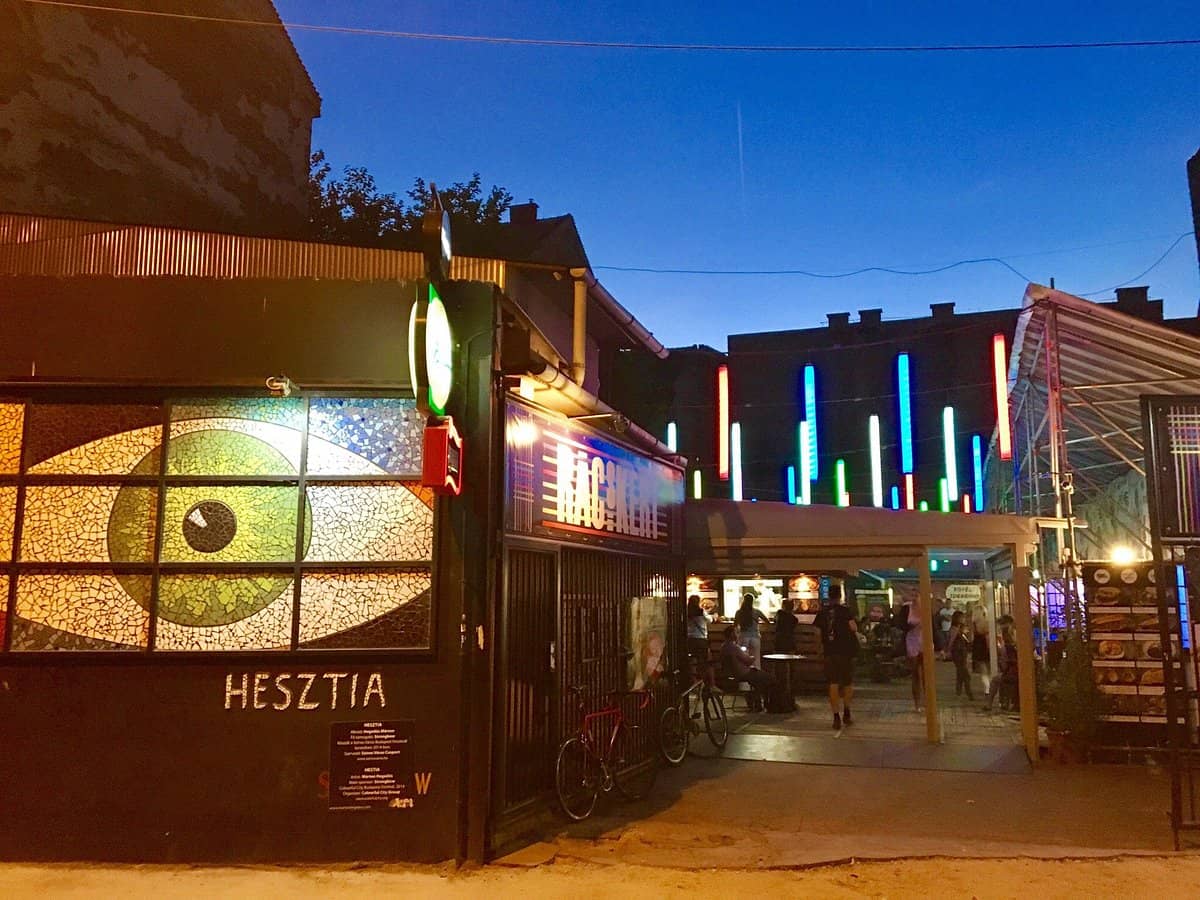 The illuminated entrance to a lively ruin bar in the Jewish Quarter at night