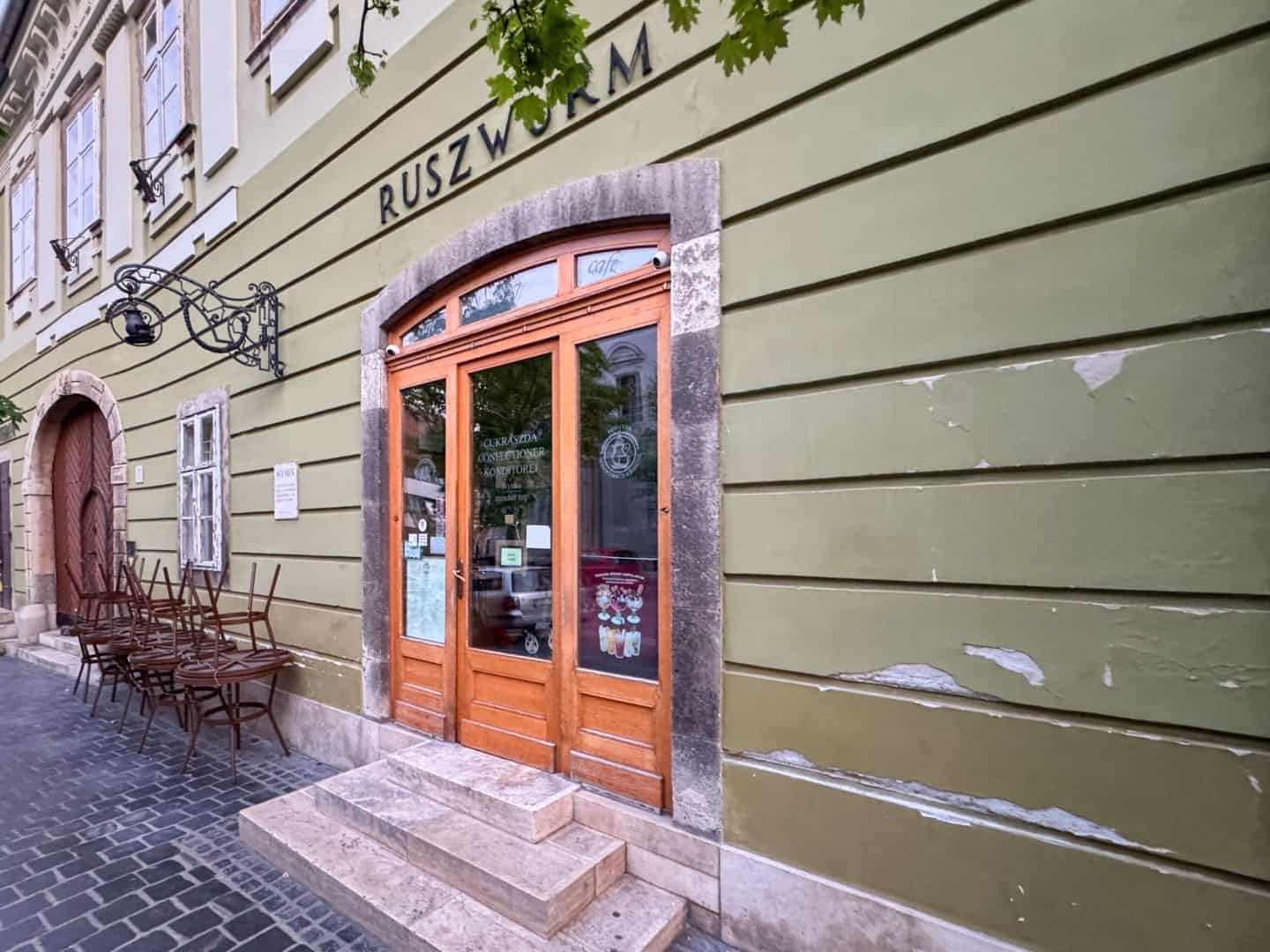 The historic exterior and outdoor seating of Café Ruszwurm in the Buda Castle District