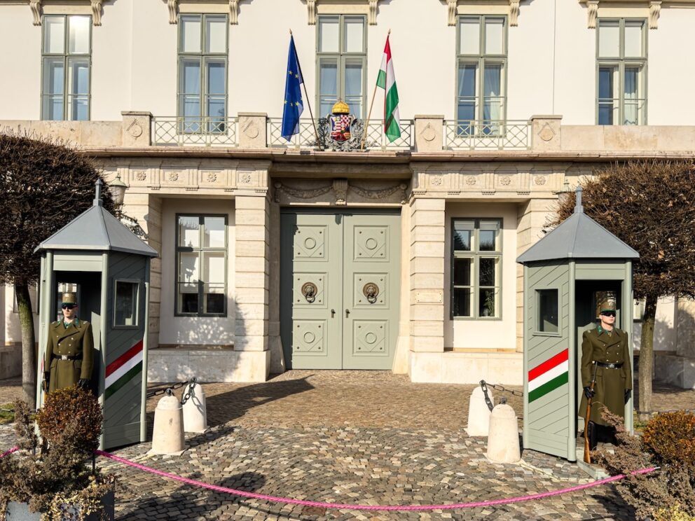 Two striped wooden sentry boxes flanking the palace entrance