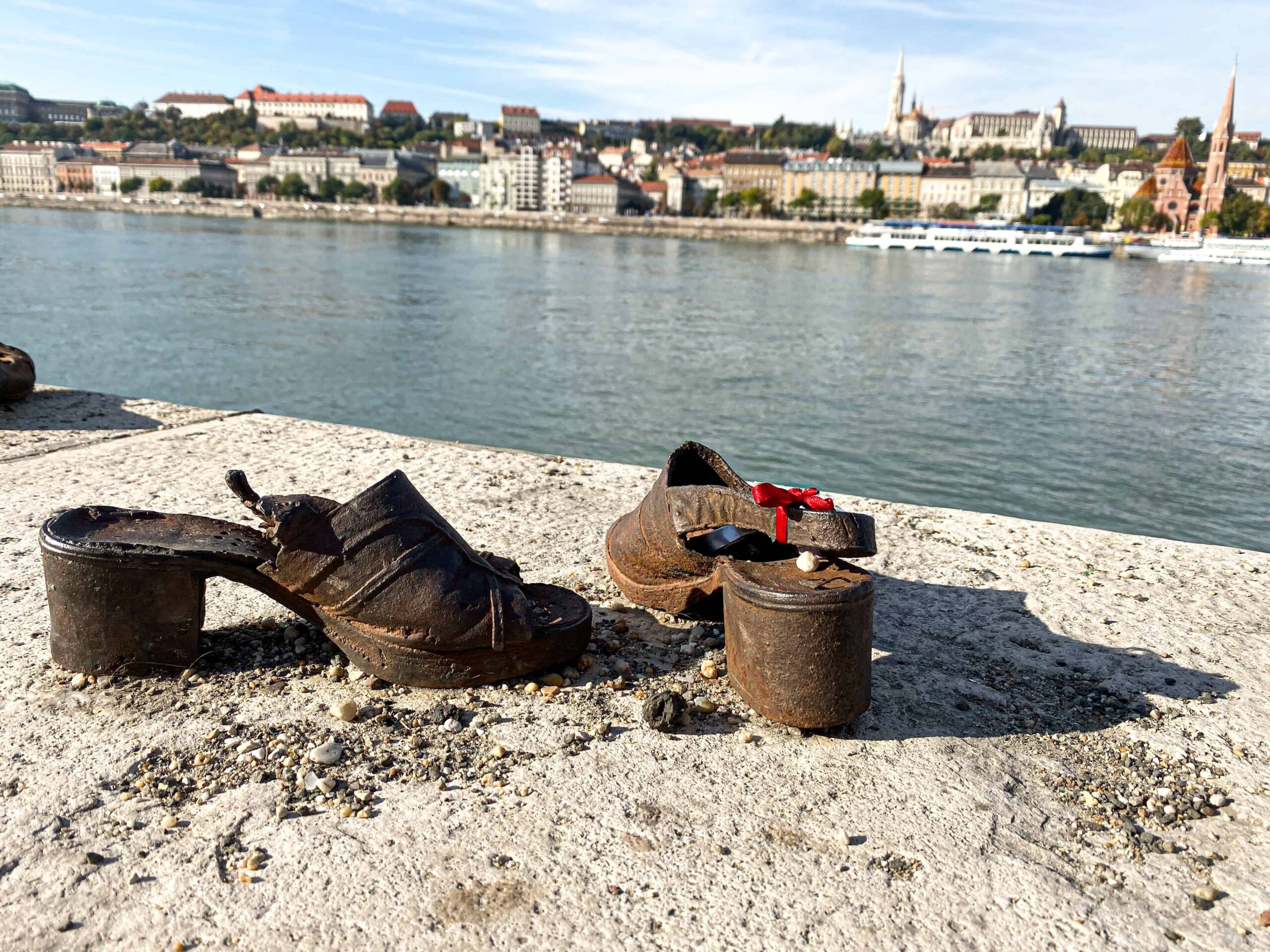 Iron sandals at the Danube memorial with a small red ribbon tied to the strap