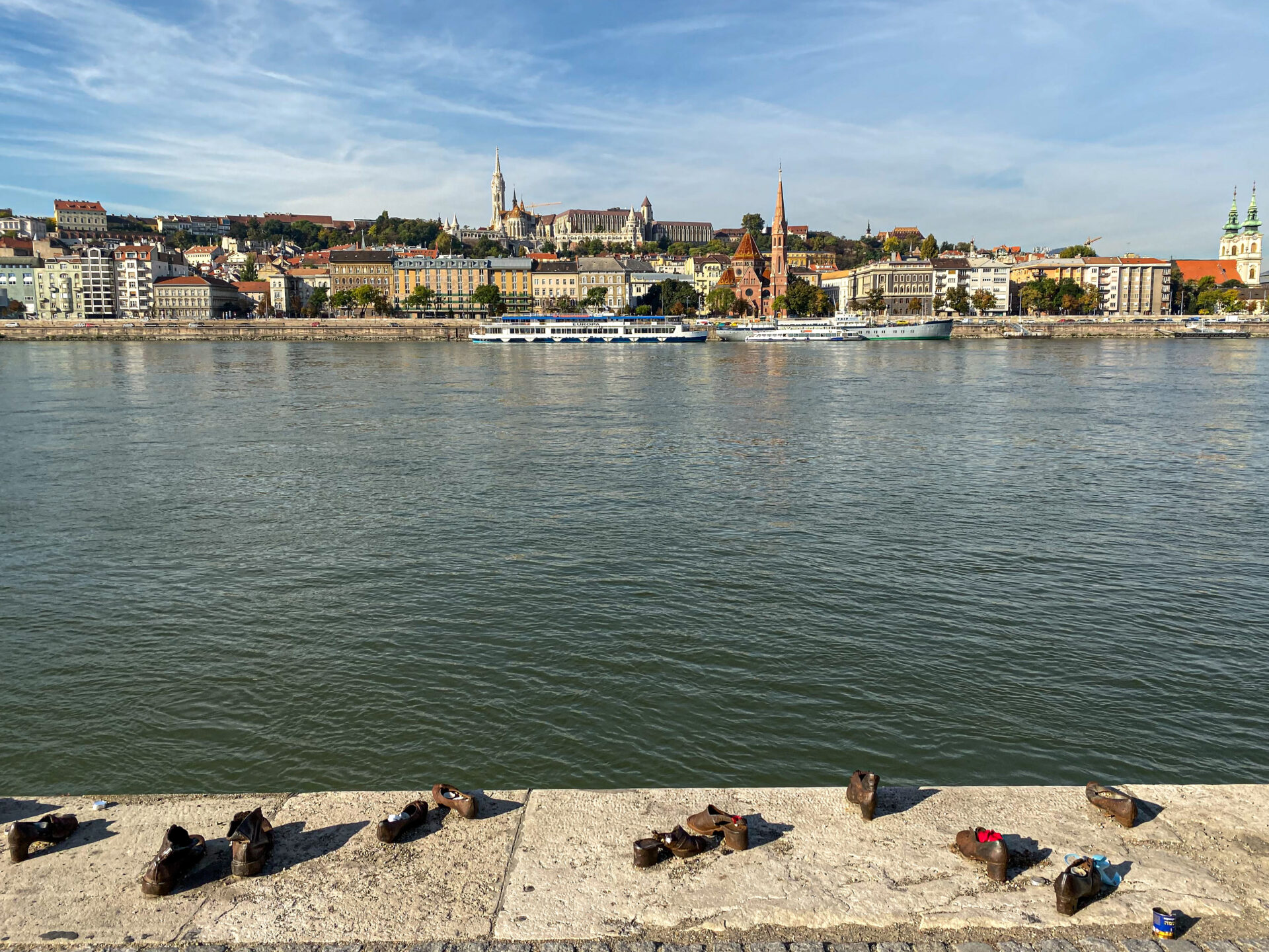 A wide view of the iron shoes lined up along the edge of the Danube river