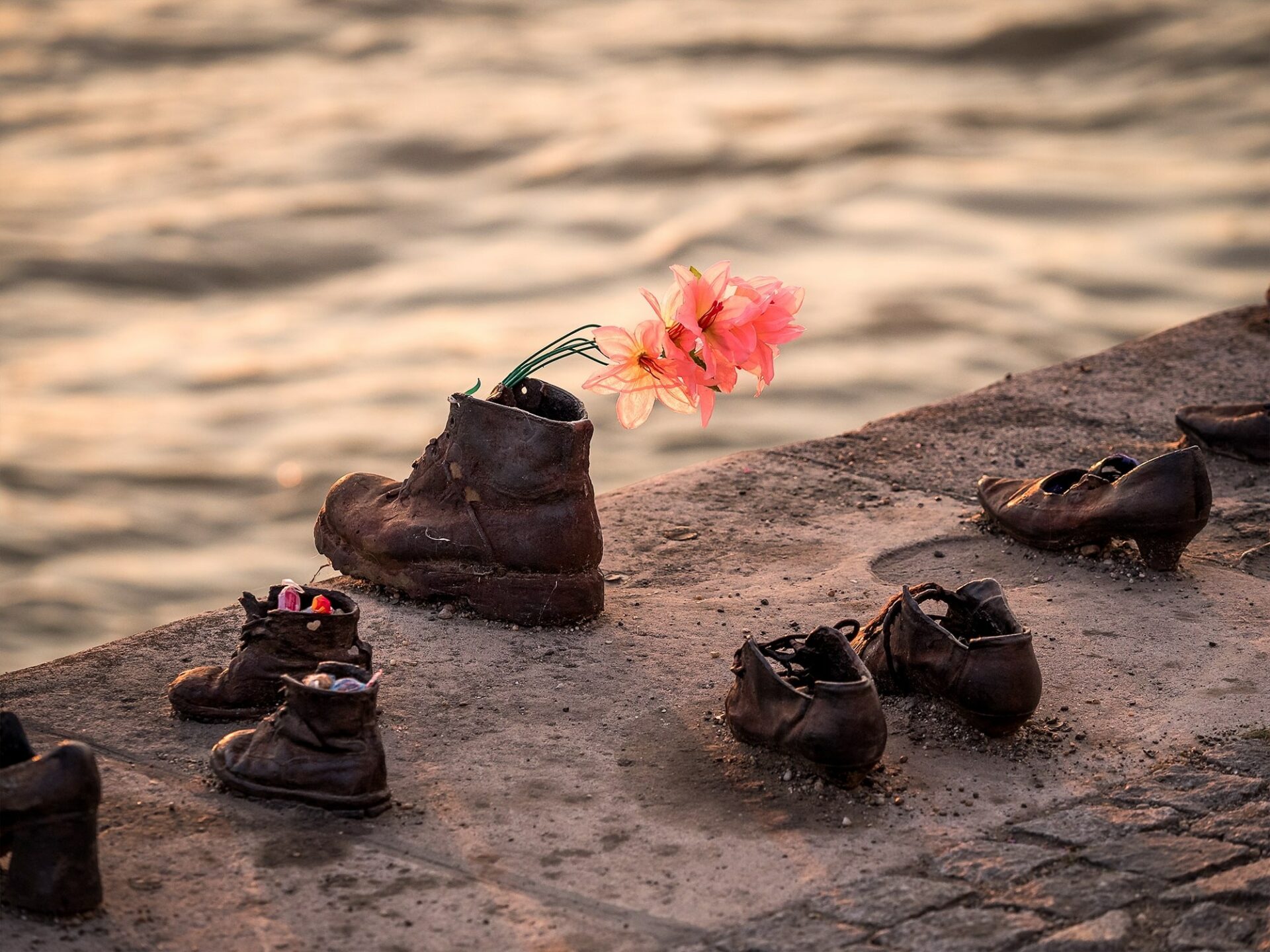 A highly solemn line of cast-iron shoes firmly rooted to the stone embankment of the Danube