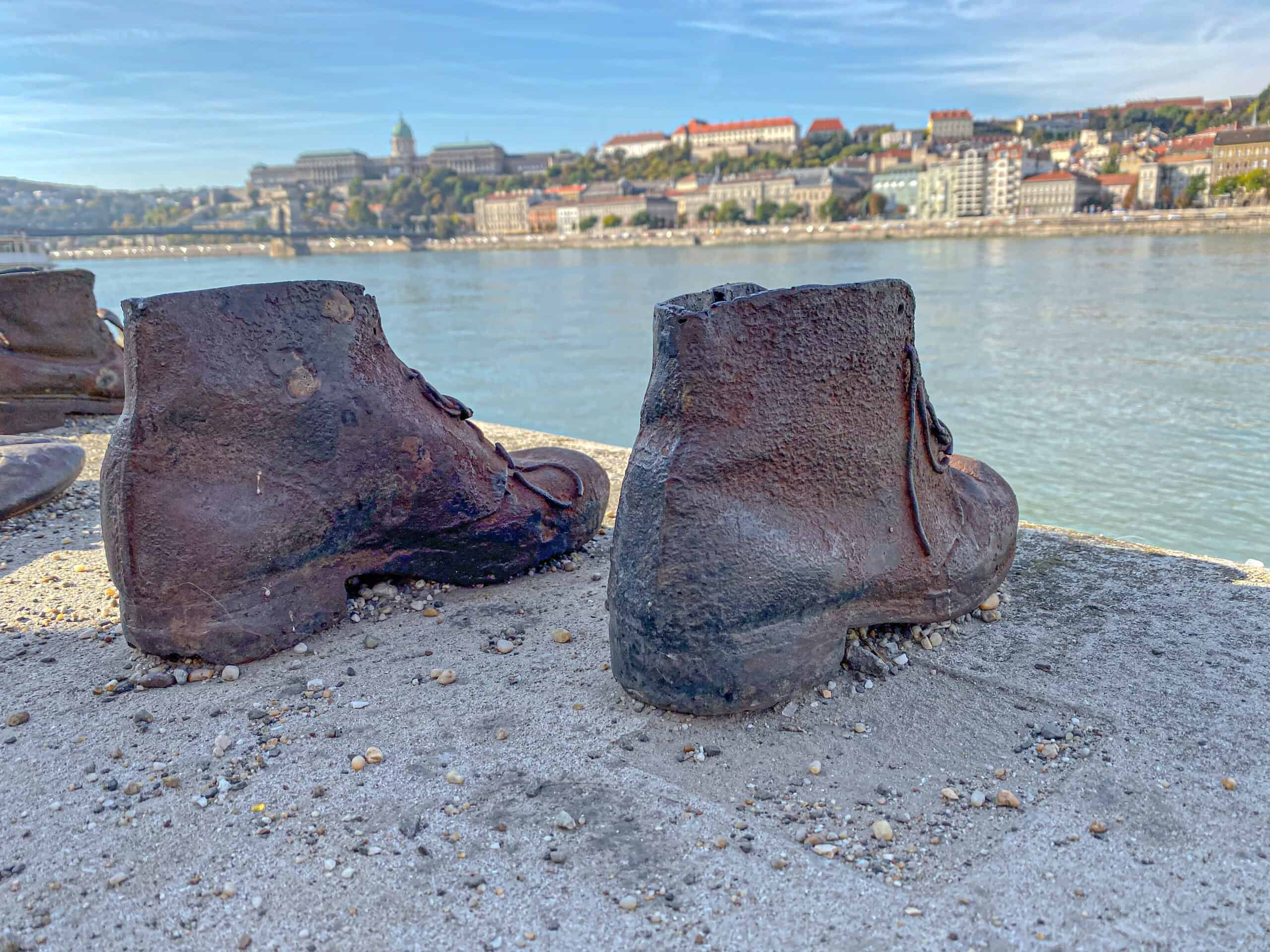 Several pairs of authentic iron shoes cast heavily into the concrete edge of the Danube riverbank