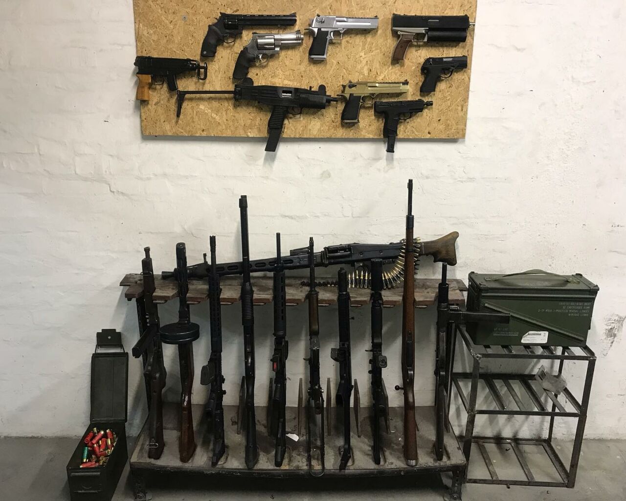 An impressive armory wall showing dozens of different handguns and long rifles