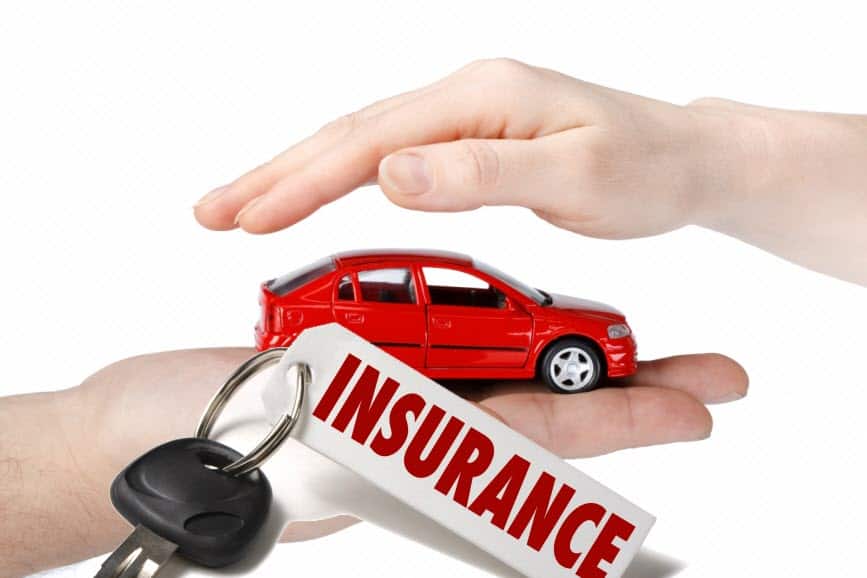 Someone signing the paperwork and insurance documents for a car rental