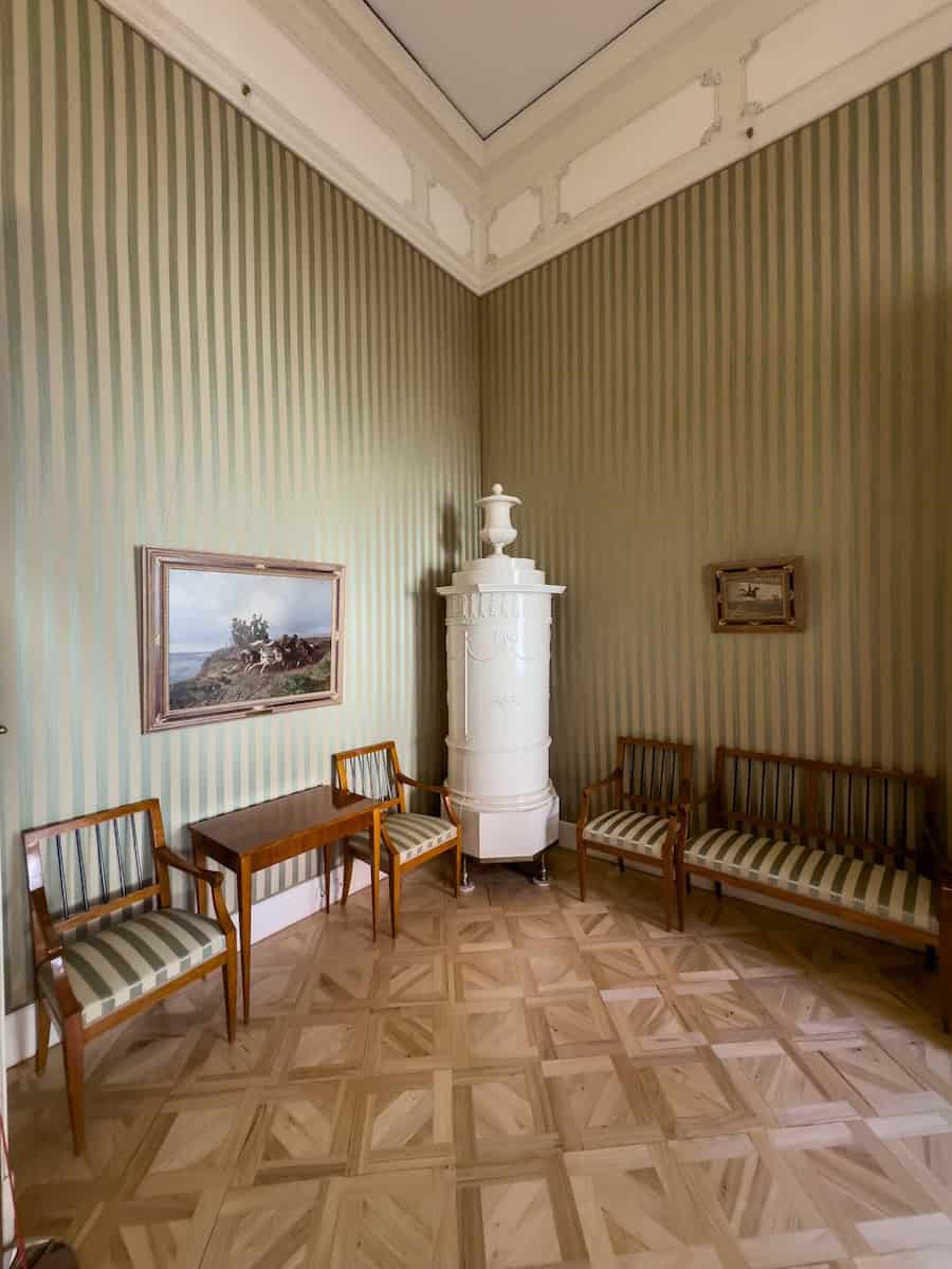 An antique cabinet in the green-walled Small Empire Salon