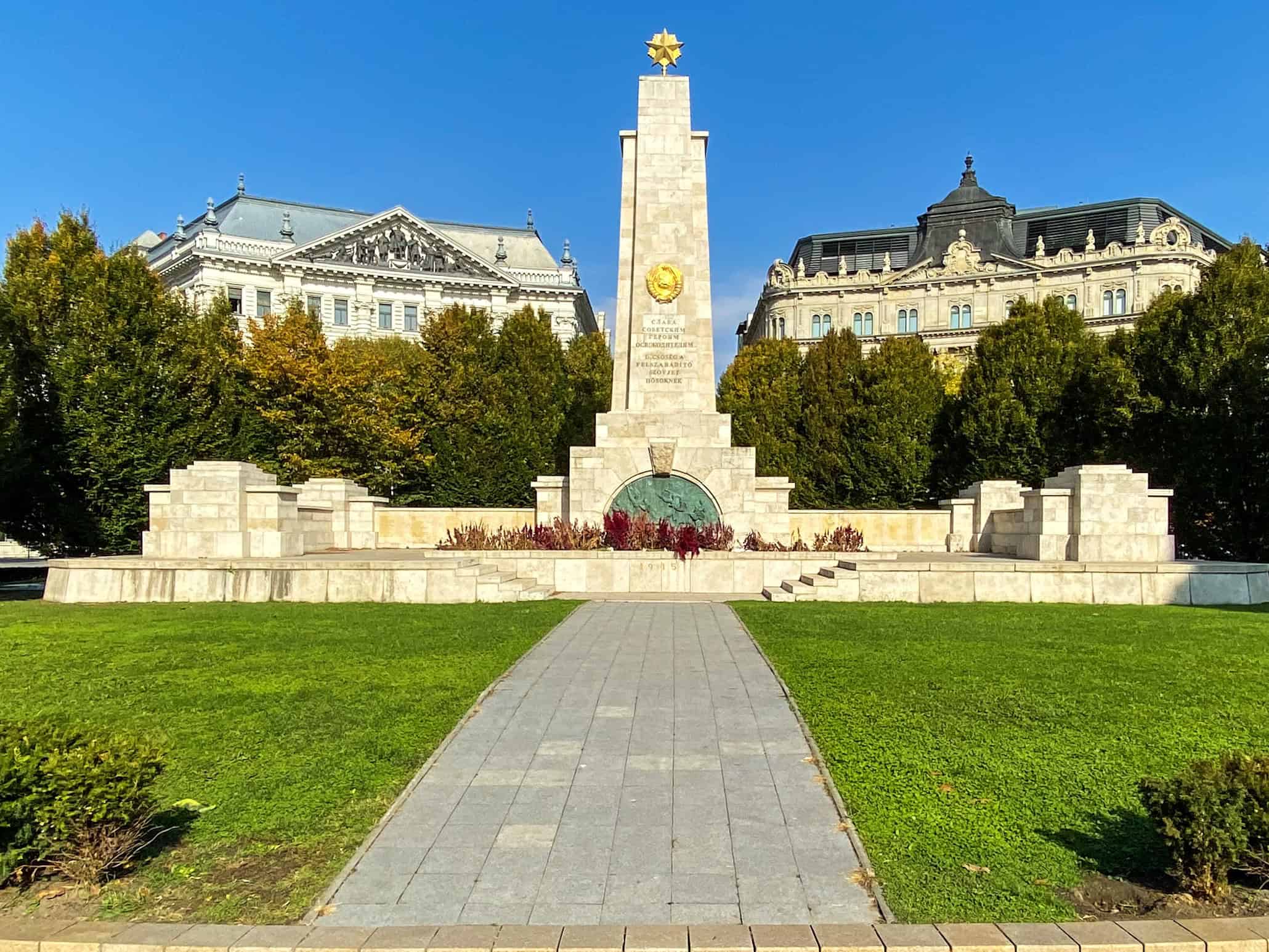 The tall stone Soviet War Memorial pillar featuring the gold star located in Liberty Square