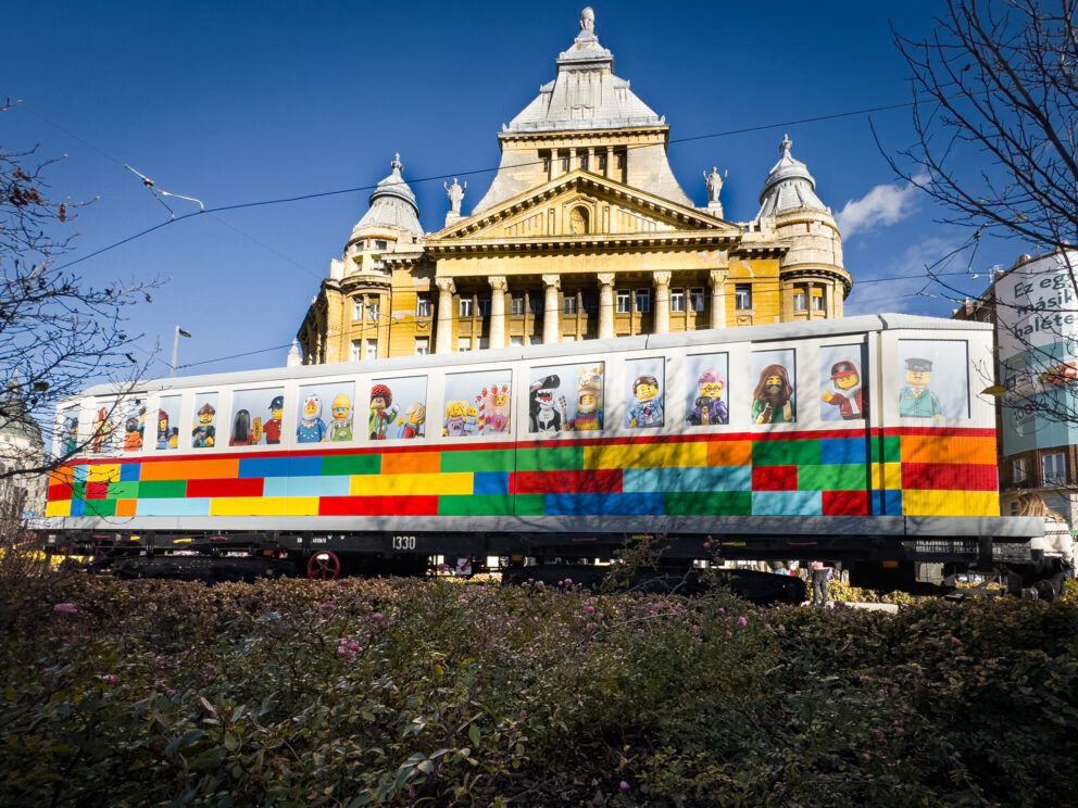 A tram decorated entirely to look like it is built from colorful LEGO bricks