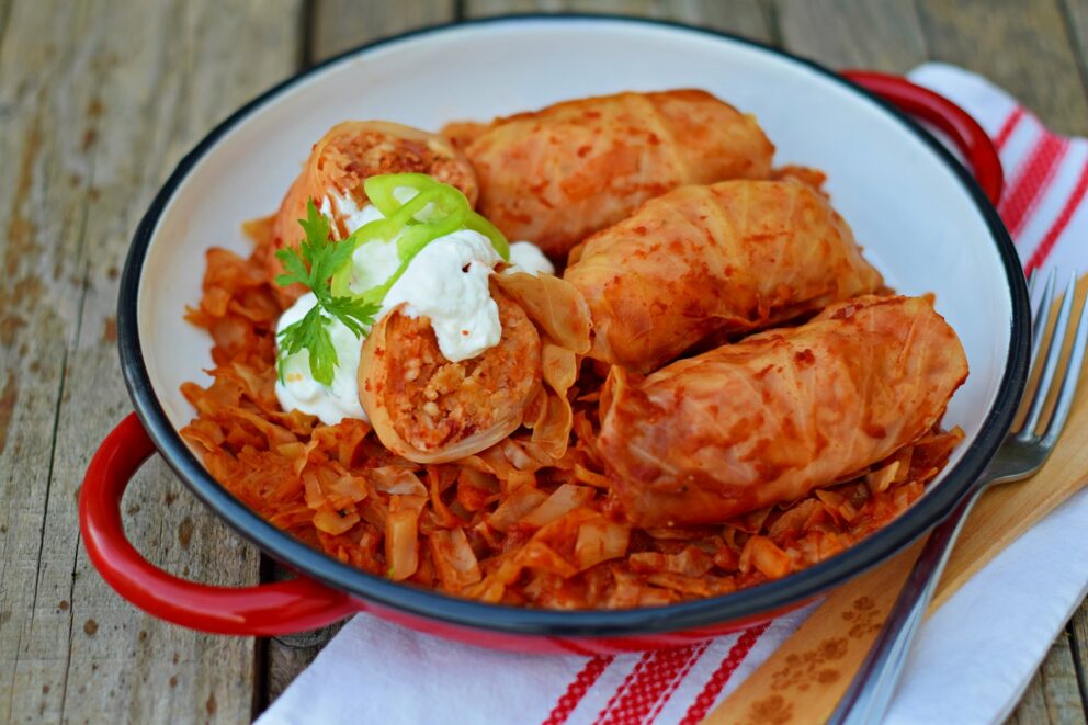 A cut-open stuffed cabbage roll showing the meat and rice filling