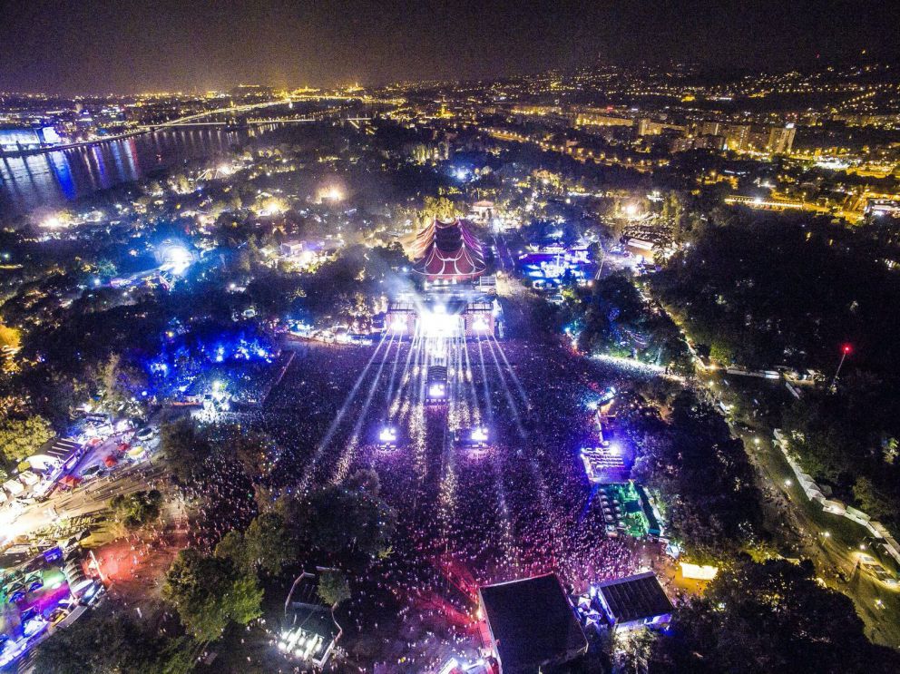 Breathtaking aerial view of the Sziget Festival lit up at night on Obuda Island