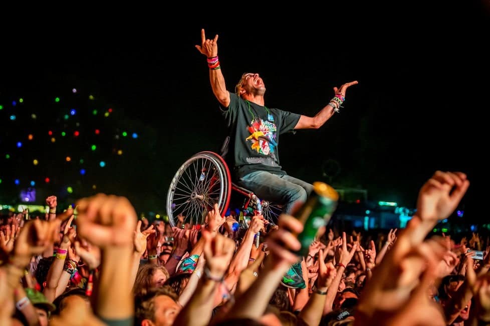 A man in a wheelchair crowd-surfing joyfully at the Sziget Festival