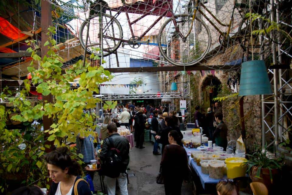 Locals browsing the lively Sunday farmers' market inside Szimpla Kert