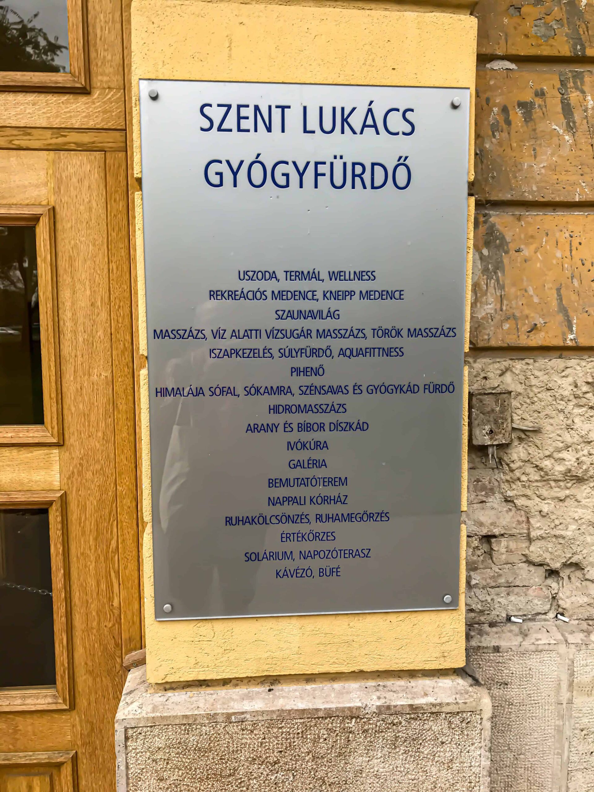 The official stone plaque at the entrance of Szt. Lukács Gyógyfürdő