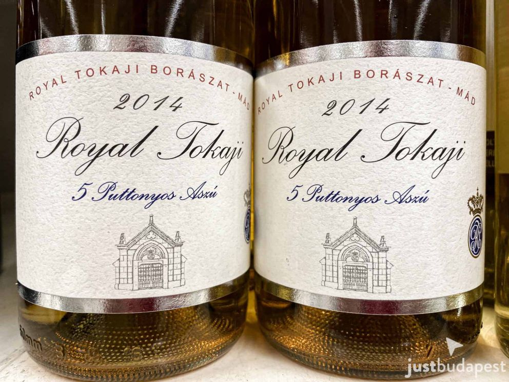 A glass of rich amber-colored Tokaji Aszu dessert wine