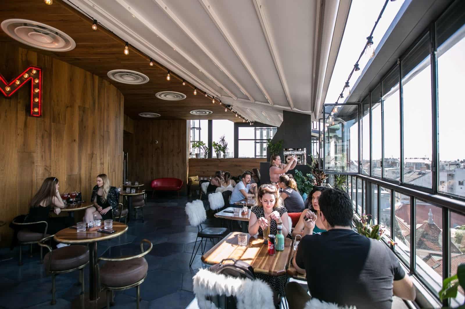The indoor rooftop setting and panoramic windows at Toprum