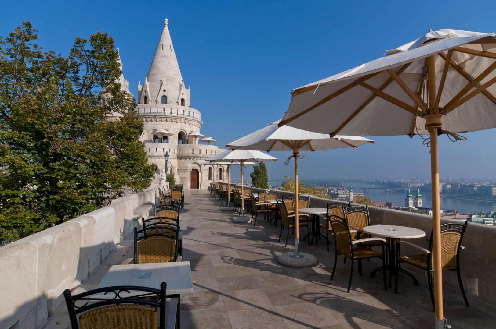 A large crowd of tourists exploring the terraces of the Fishermen's Bastion during the day