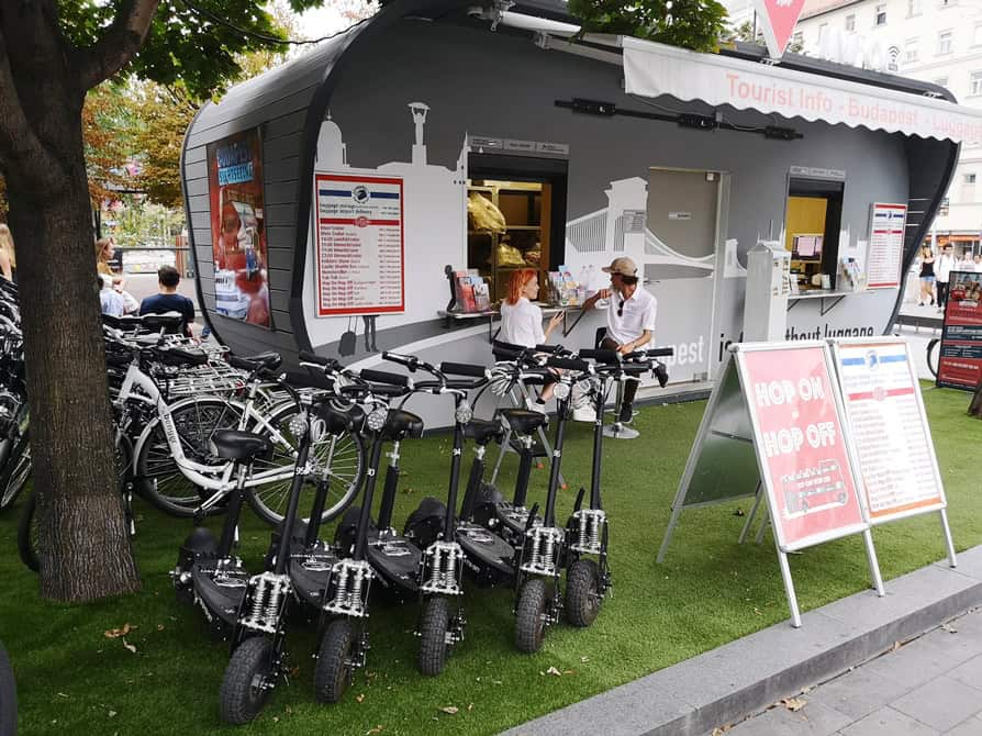 A tourist kiosk offering bike and electric scooter rentals