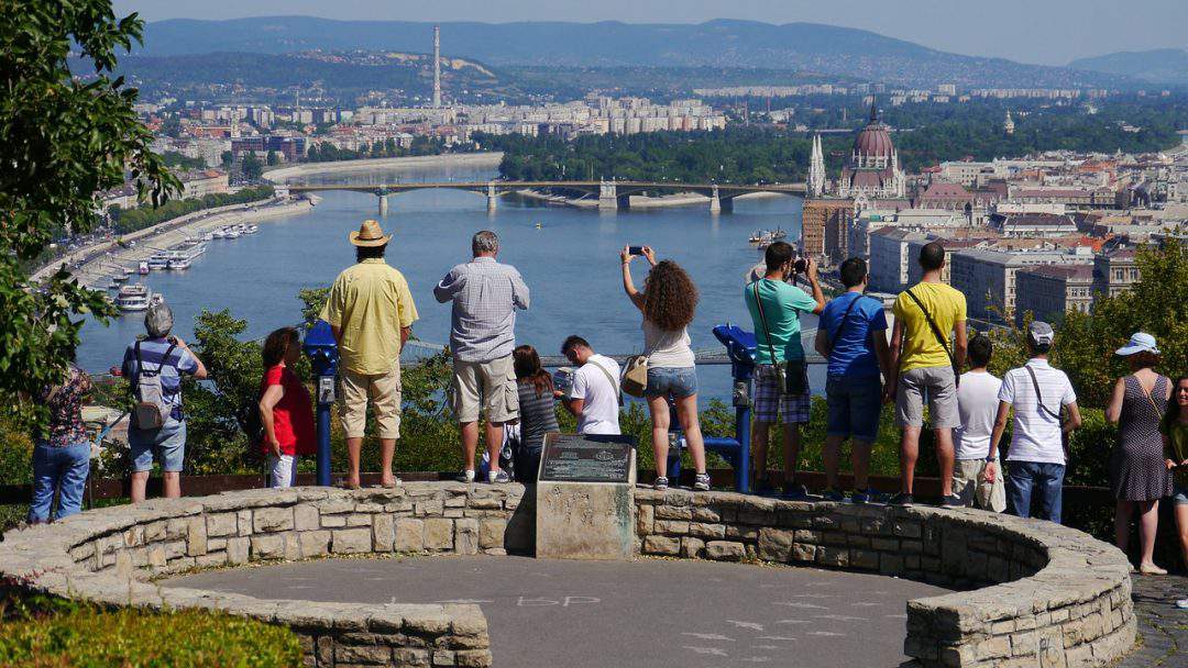 Tourists enjoying the panoramic city views from Gellért Hill
