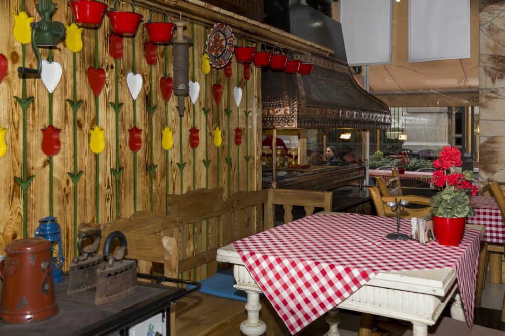 The cozy, wood-paneled interior of a traditional Hungarian 'Csarda' restaurant