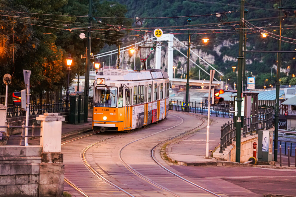 A classic yellow tram running along the incredibly scenic Line 2 route beside the Danube
