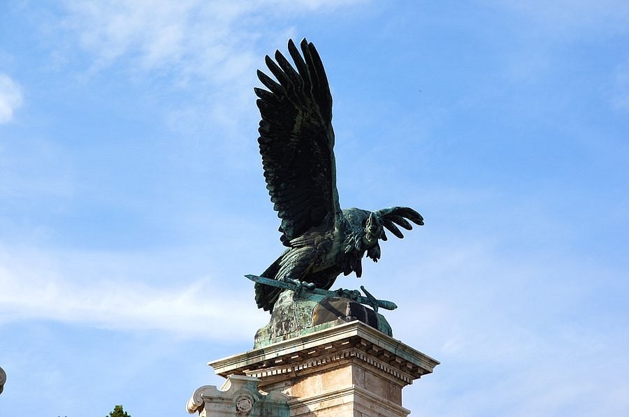 The Turul bird statue with its massive bronze wings spread high