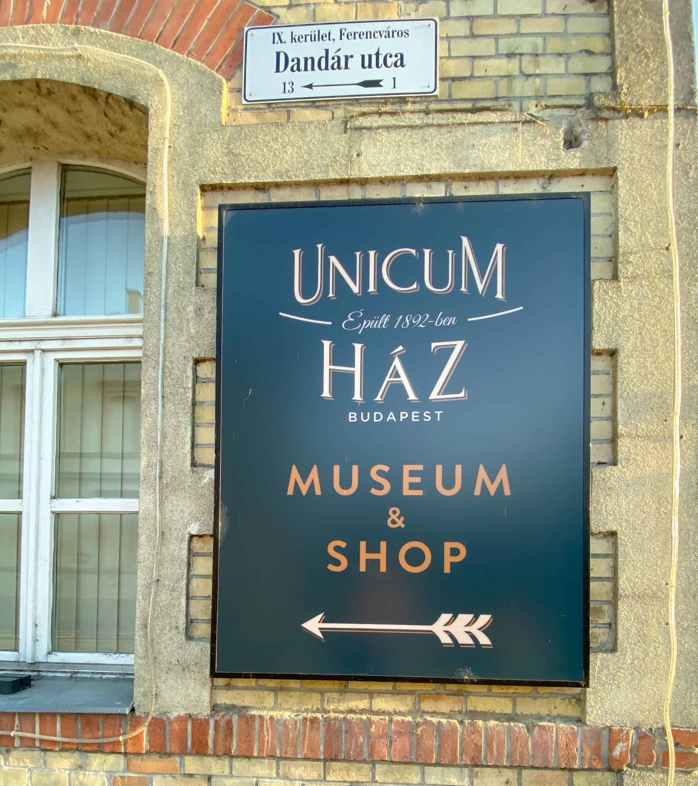 Directional sign for the Unicum Museum and Shop on Dandár utca