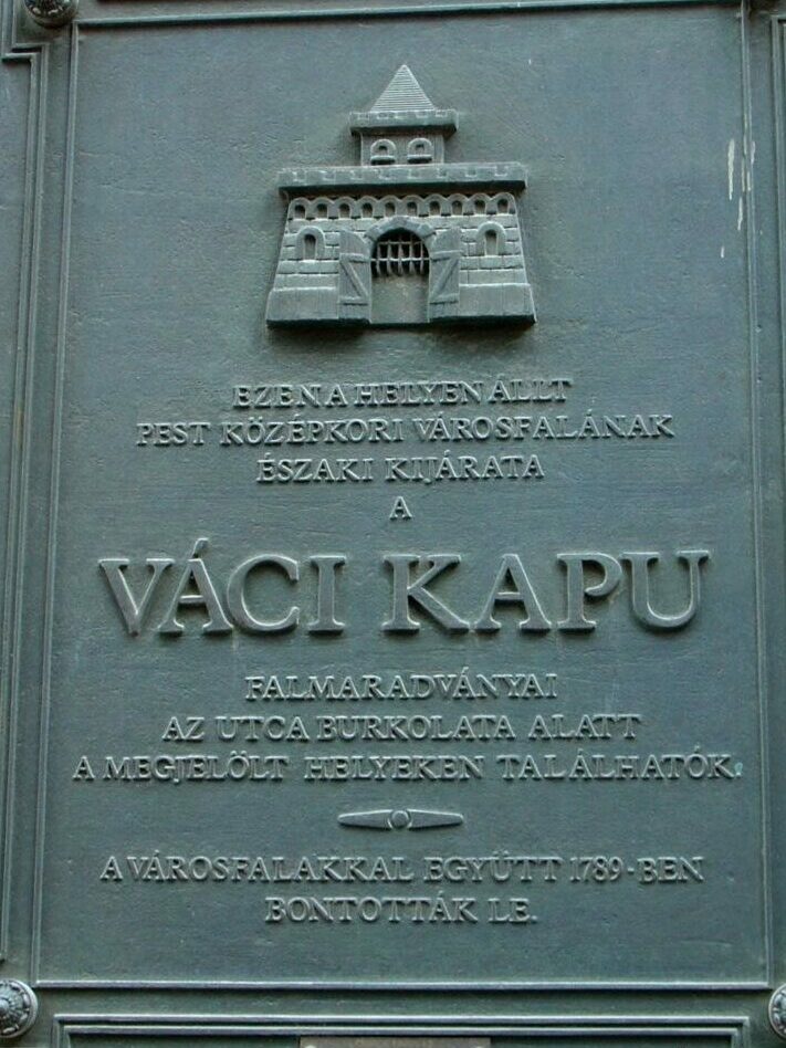 Bronze memorial plaque marking the former location of the Vaci Gate