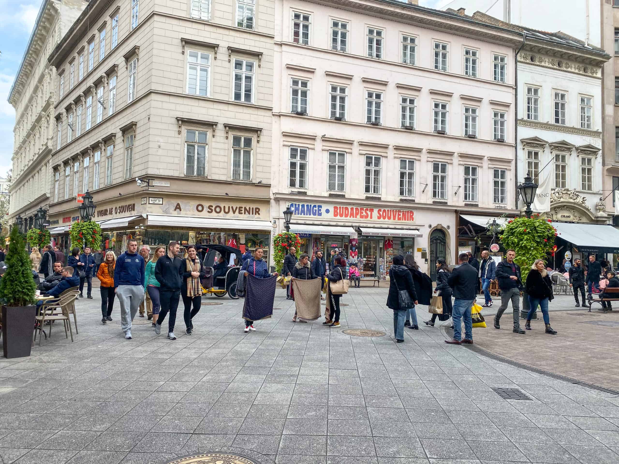 A busy afternoon on Vaci utca, Budapest's premier pedestrian shopping street with various retail stores.