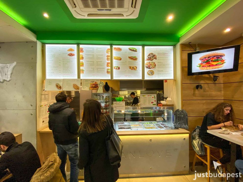The modern, green interior of Vegan Love on the Buda side