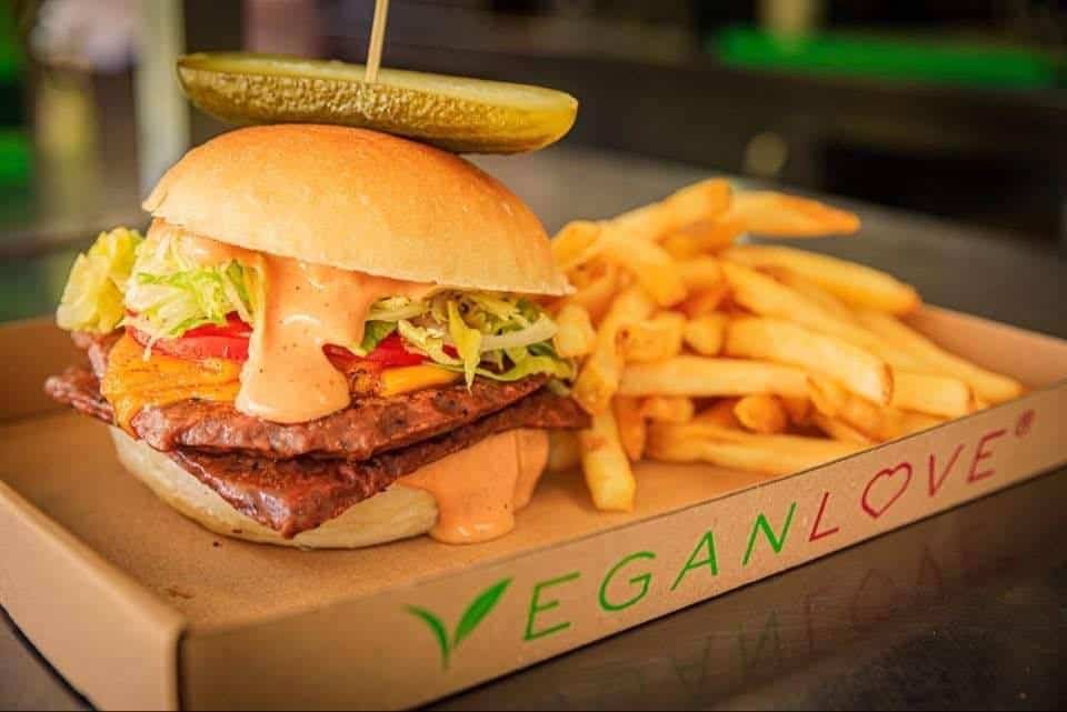A messy and delicious vegan burger with fries from Vegan Love