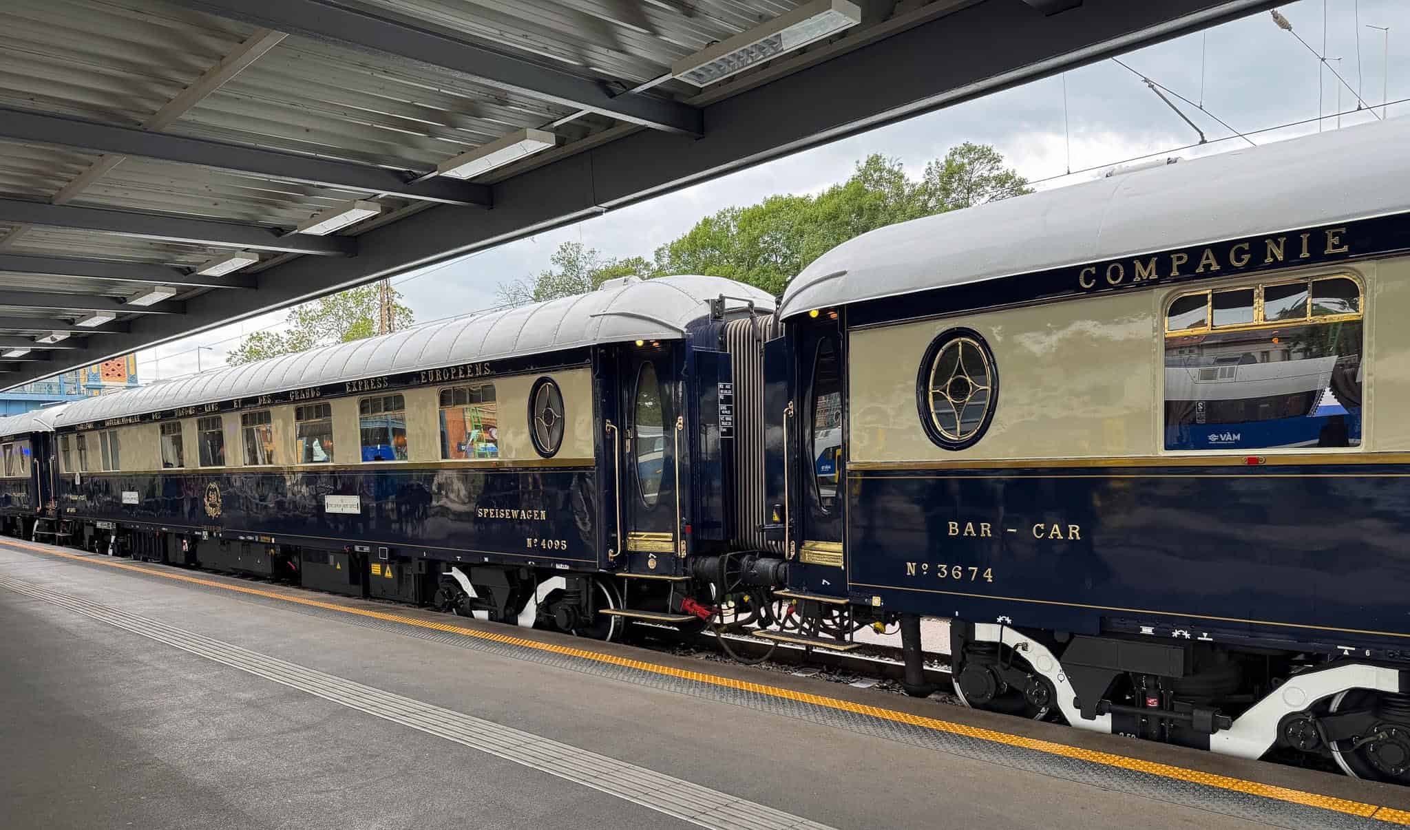 The iconic blue and white Venice Simplon-Orient-Express train at a Budapest station