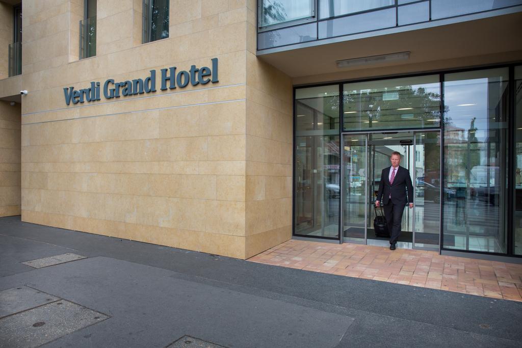 The modern facade of the Verdi Grand Hotel in District 9