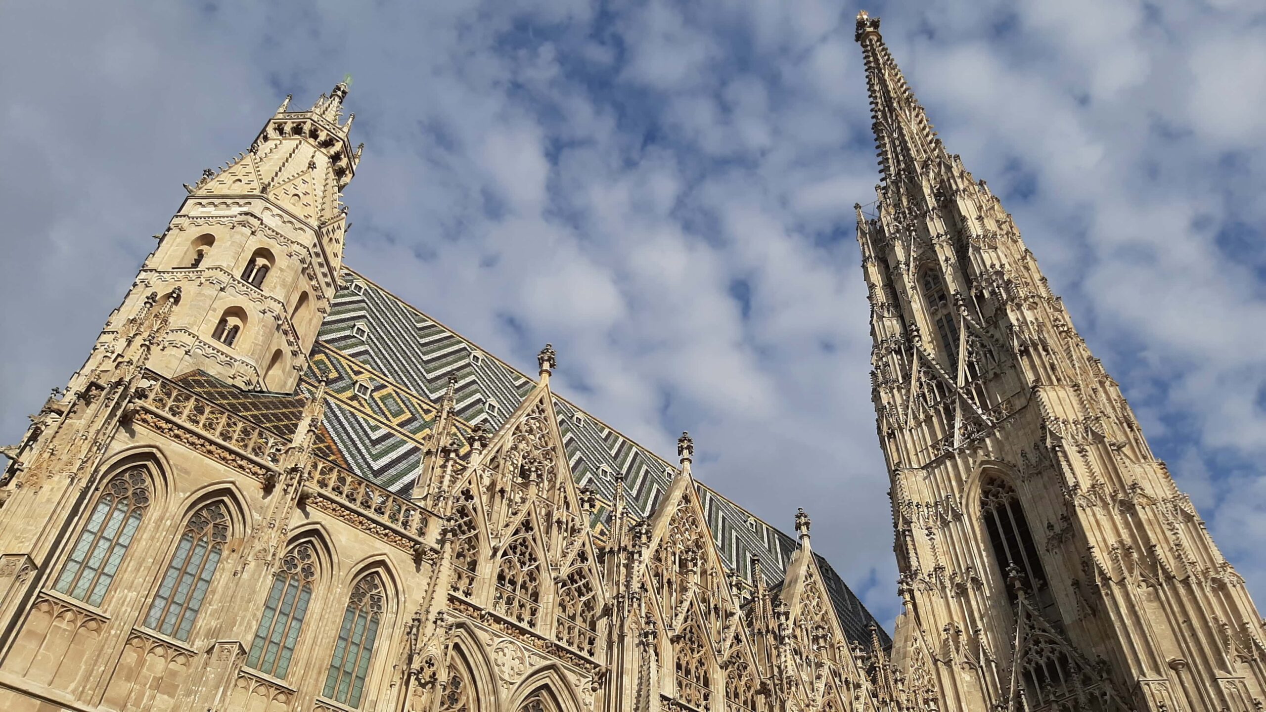Historic buildings lining a busy street in the center of Vienna, Austria