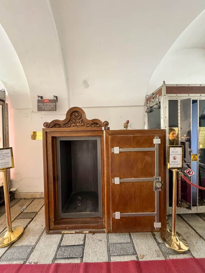 A vintage wooden illusion cabinet on display at the museum