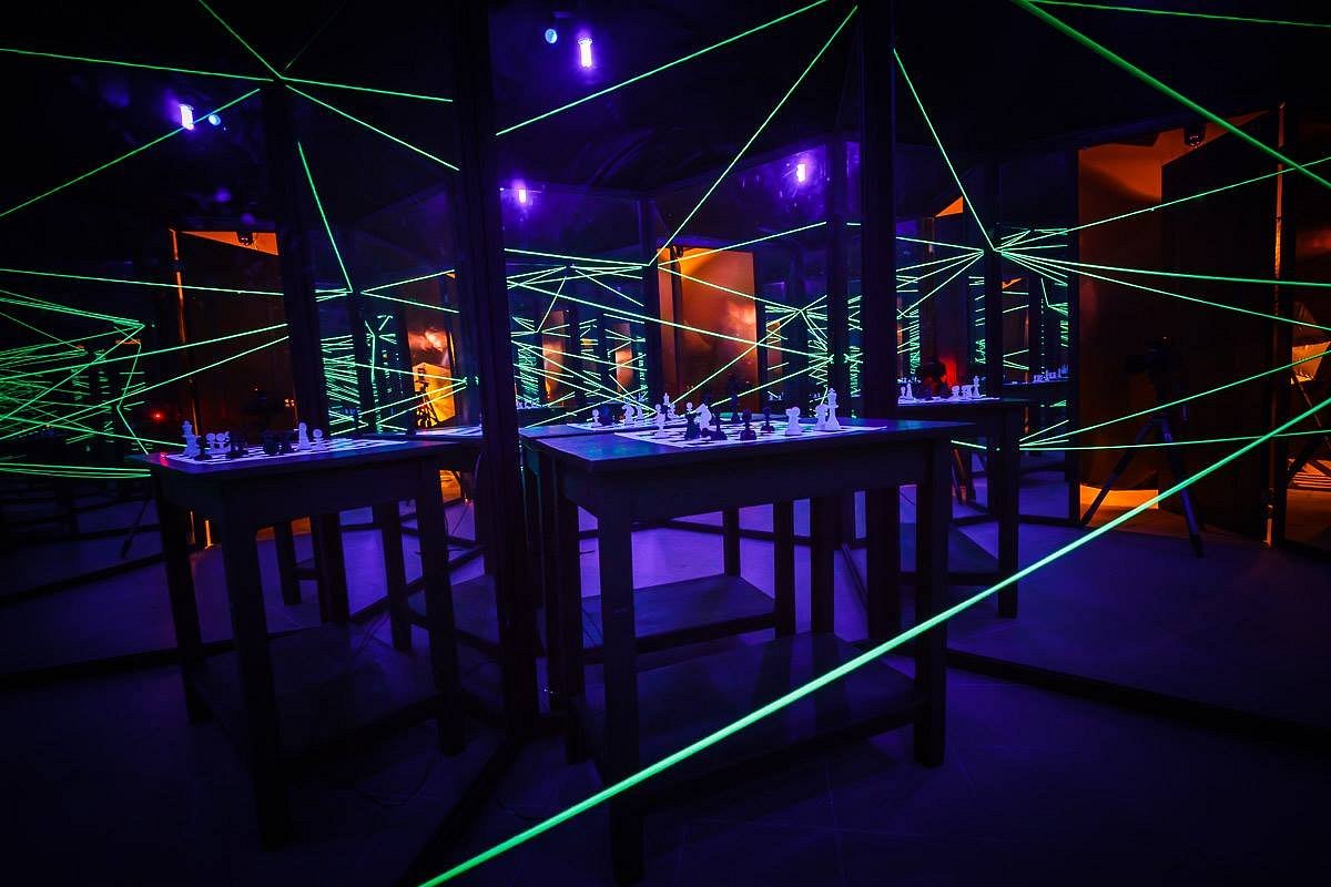 Hands manipulating the dials on a vintage brass padlock attached to a chest