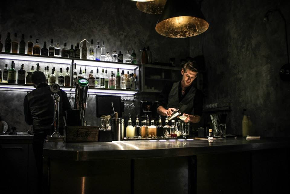A bartender using molecular mixology techniques to smoke a cocktail at Warm Up
