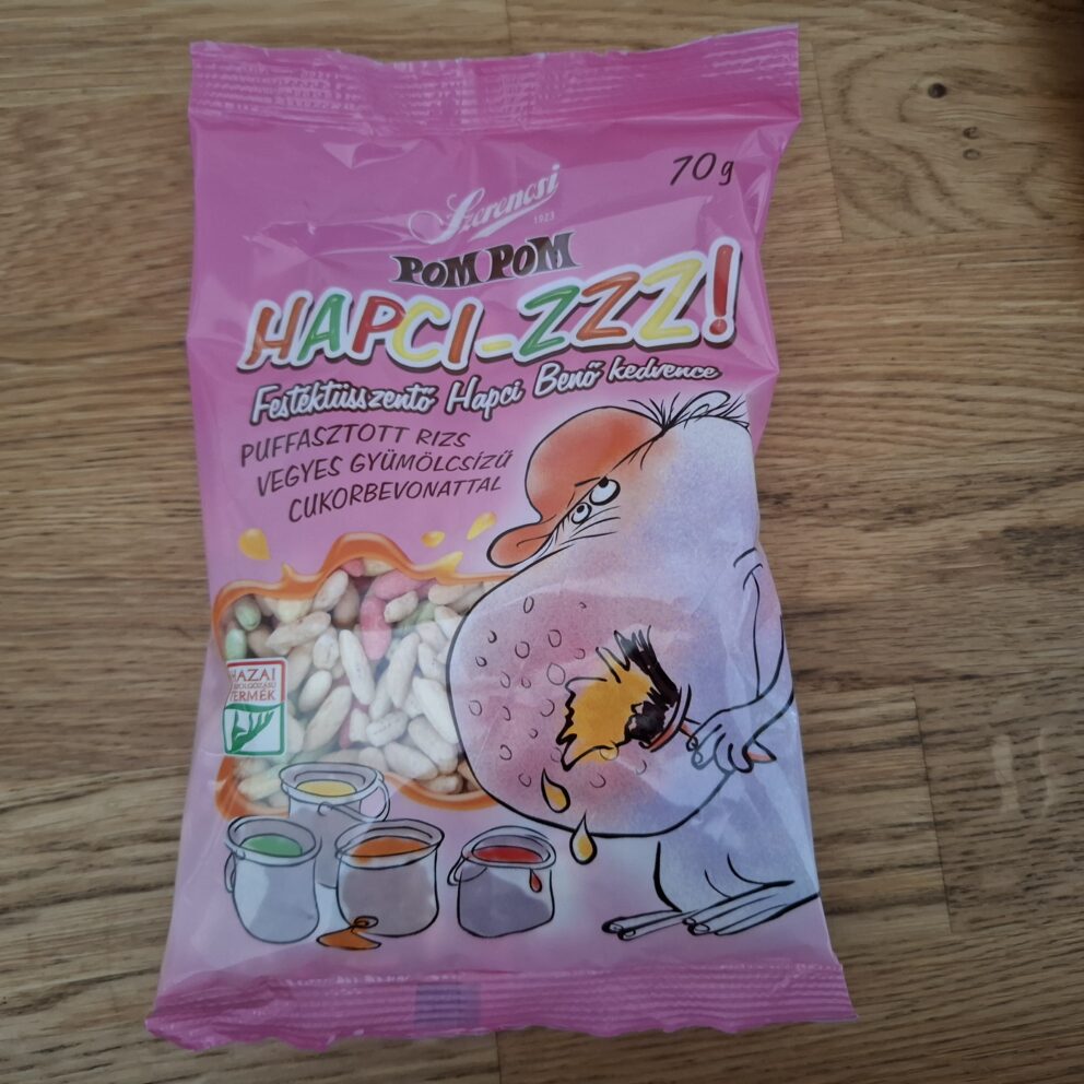 A pile of brightly colored neon pink, green, and yellow Zizi puffed sugar candies