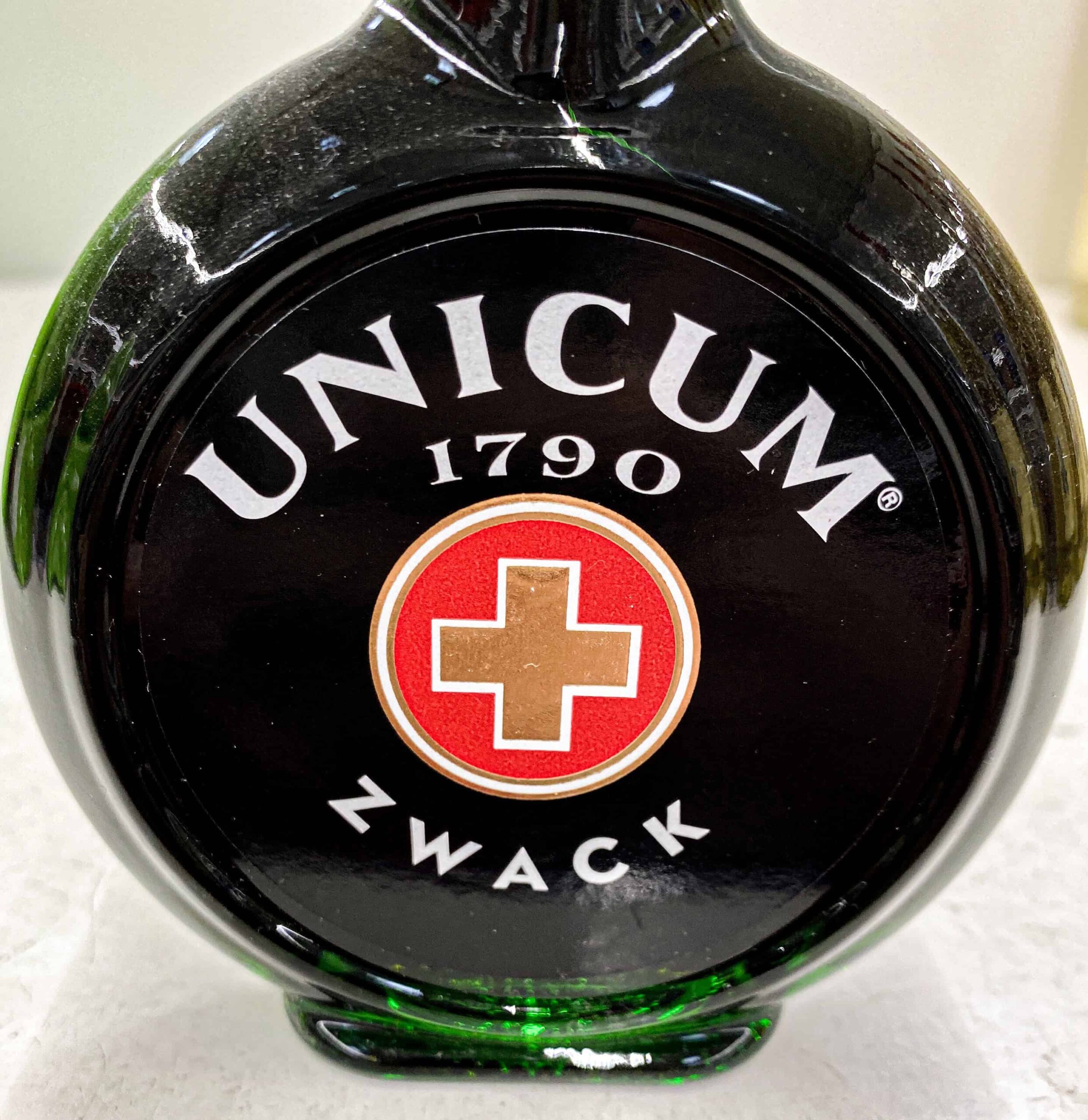 A round, dark green bottle of traditional Hungarian Unicum